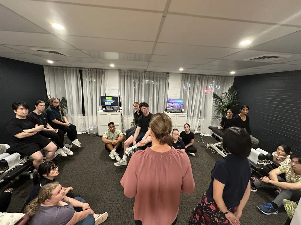Students in a group learning when Chiro is Teaching